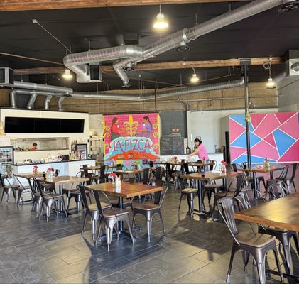 Tables and colorful wall art inside La Picza in Arroyo Grande
